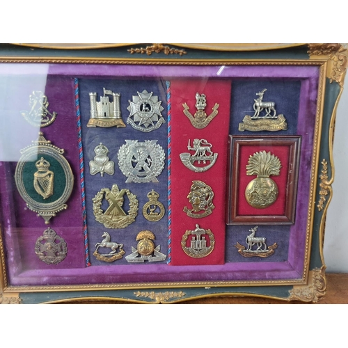 58 - A stunning framed display of Military cap badges.