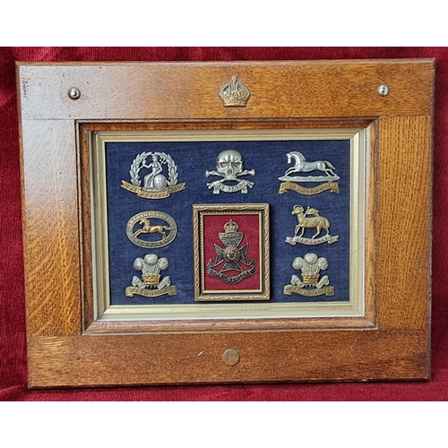 68 - A stunning framed display of Military cap badges.