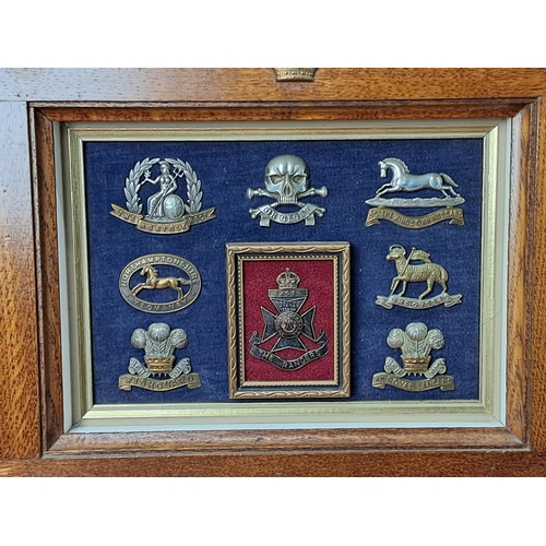 68 - A stunning framed display of Military cap badges.