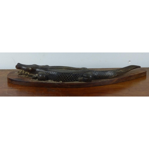 17 - A stunning oceanic carved alligator mounted on wooden base. Approx 35cm in length.