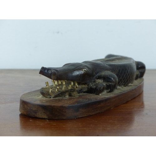 17 - A stunning oceanic carved alligator mounted on wooden base. Approx 35cm in length.