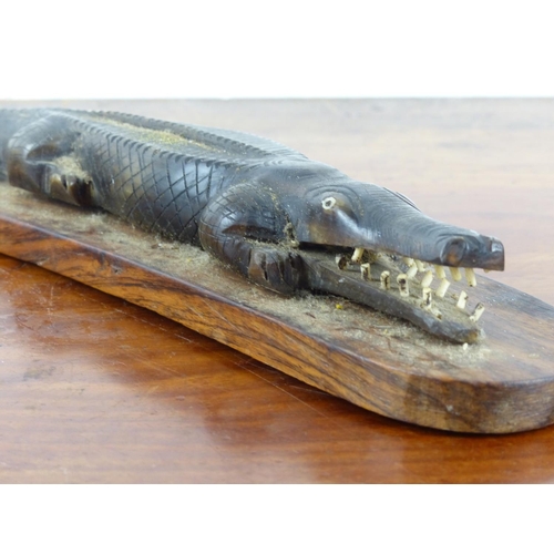 17 - A stunning oceanic carved alligator mounted on wooden base. Approx 35cm in length.