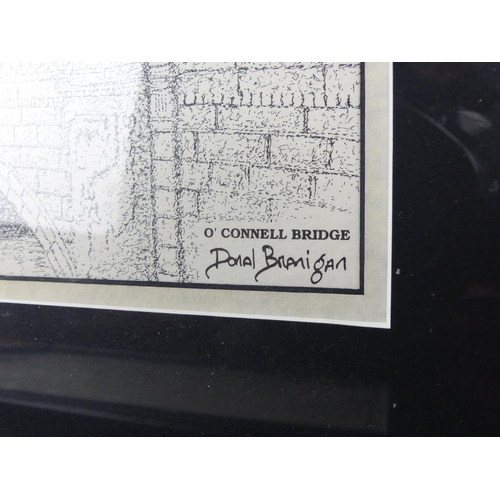 27 - Two framed Irish prints of O'Connell Bridge and Trinity College by Donal Branigan