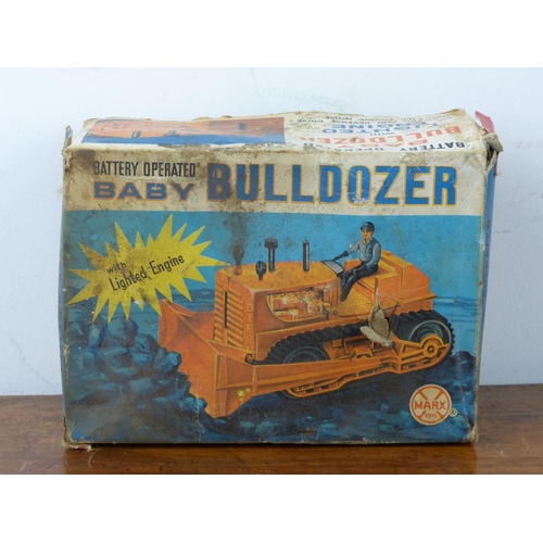 28 - A battery operateds 'BABY BULLDOZOR' with lighted engine by Marx Toys, complete with original card b... 