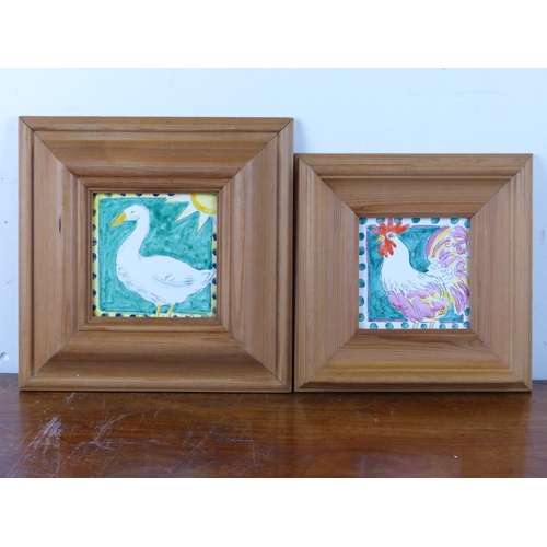 33 - Two framed hand painted tiles, depicting birds.