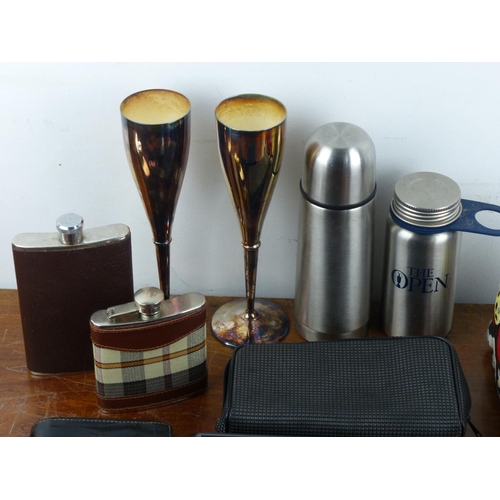 105 - An assortment of items to include hip flasks, silver plated champagne flutes & more.