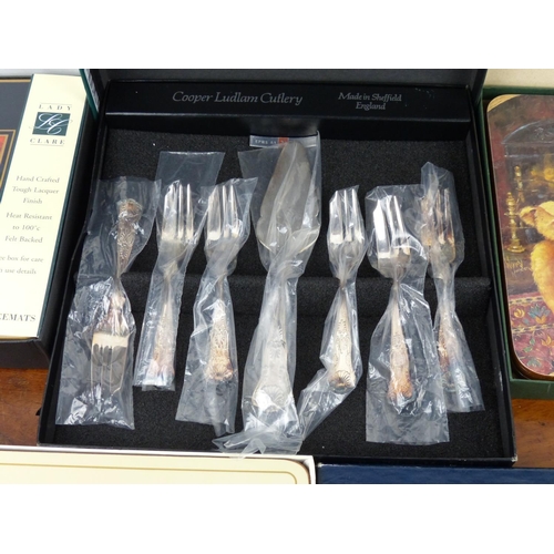 123 - A set of Cooper Ludlam pastry forks, along with 3 sets of placemats.