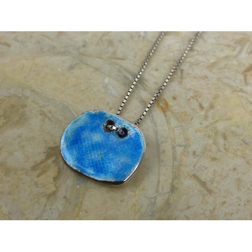 242 - An unusual sterling silver & enamel pendant & chain.