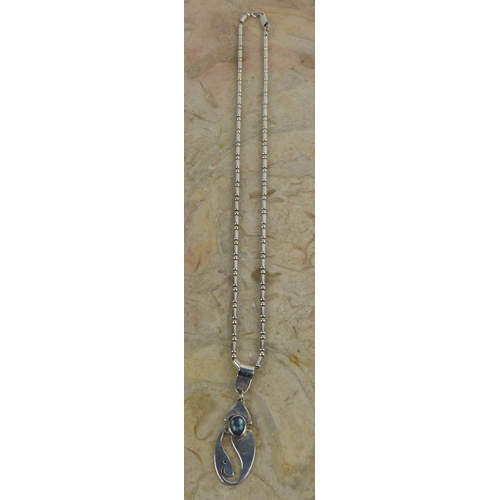 243 - A decorative sterling silver pendant & chain. Weighing 20.64 grams.