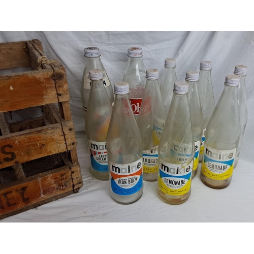 176 - A vintage wooden Maine Soft Drinks Ballymoney crate & assortment of bottles.