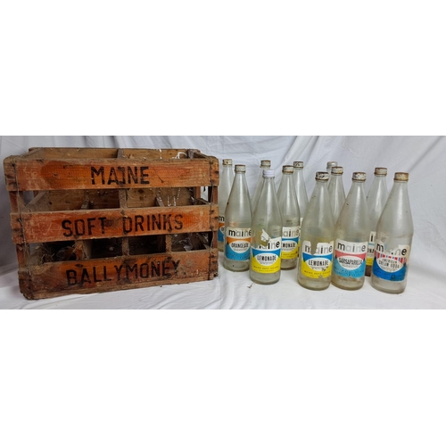 177 - A vintage wooden Maine Soft Drinks Ballymoney crate & assortment of bottles.