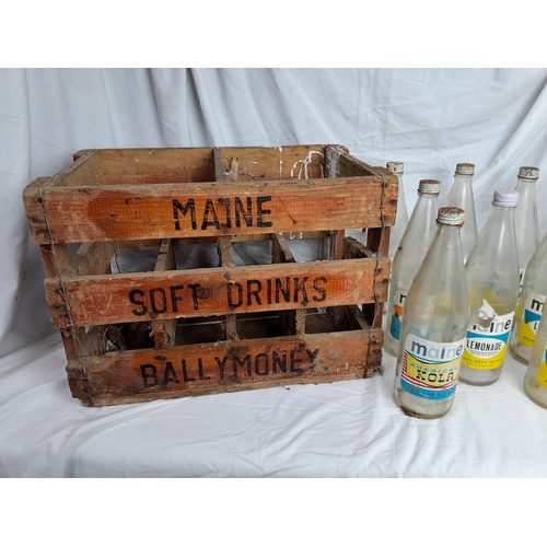 177 - A vintage wooden Maine Soft Drinks Ballymoney crate & assortment of bottles.