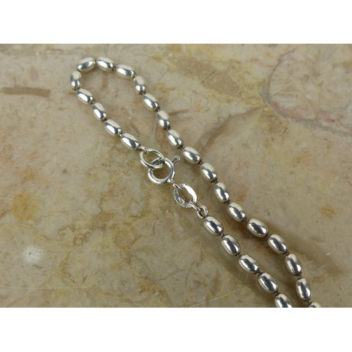 262 - A Sterling Silver beaded necklace. .431 grams.