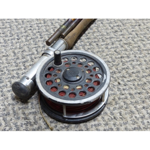 298 - An antique split cane fishing rod with reel.