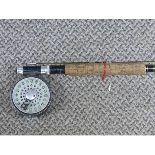 299 - A vintage fishing rod with reel.