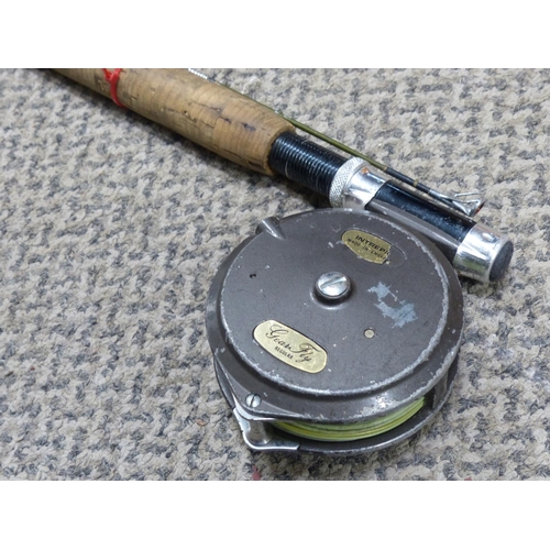 299 - A vintage fishing rod with reel.