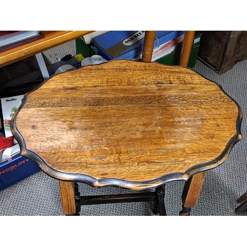 312 - An antique oak lamp table with barley twist legs.