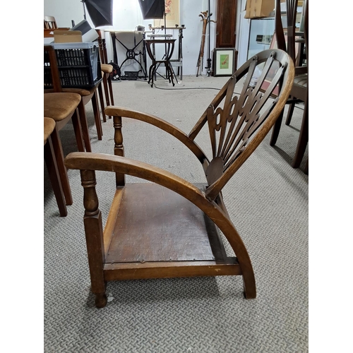 326 - An unusual antique/ art deco fireside chair with decorative back panel.