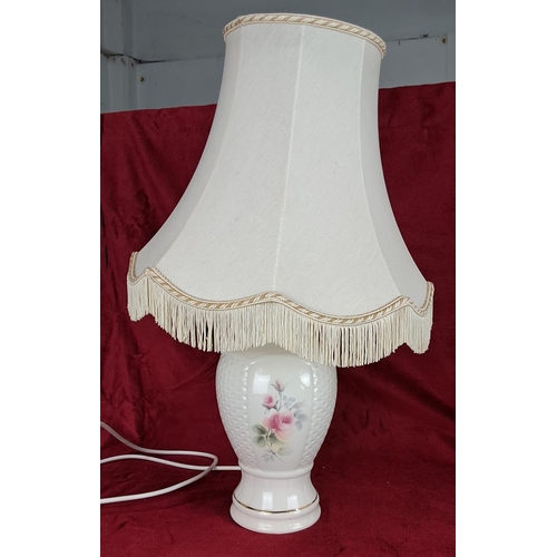 438 - A decorative Donegal Pottery table lamp with shade.