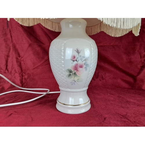 438 - A decorative Donegal Pottery table lamp with shade.