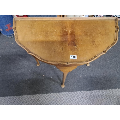 440 - A vintage Demi Lune table.