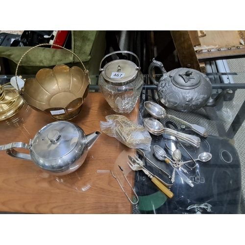 467 - An assortment of metal ware to include teapots & more.