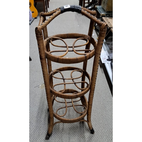 486 - A vintage rattan 3 tier plant stand.