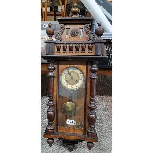 493 - A decorative antique wood cased wall clock.