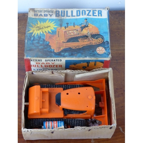 28 - A battery operateds 'BABY BULLDOZOR' with lighted engine by Marx Toys, complete with original card b... 