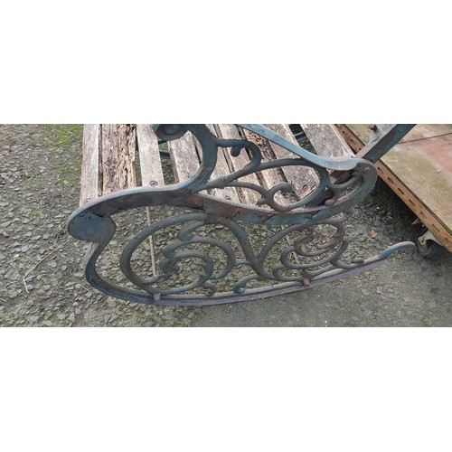 179 - An outdoor rocking chair with cat iron ends, in need of restoration.