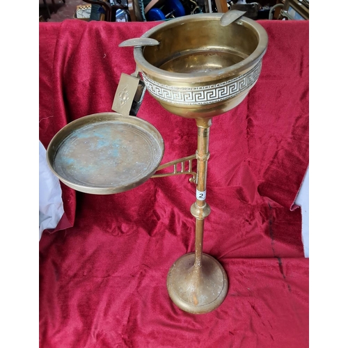 2 - A vintage brass floor standing smokers stand.