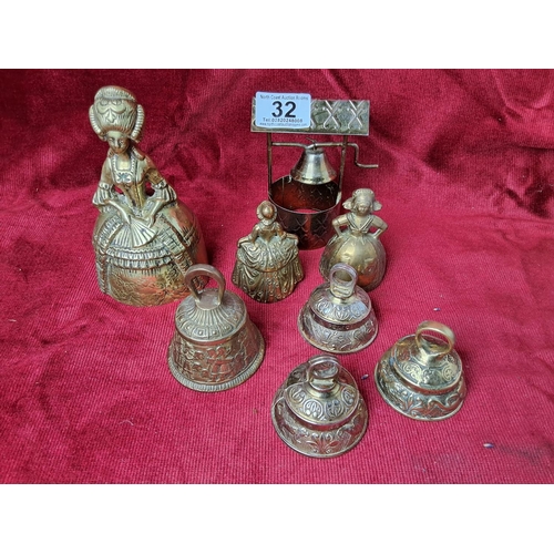 32 - A collection of various vintage/ antique brass bells. Including a sanctuary / Sanctus bell, depictin... 