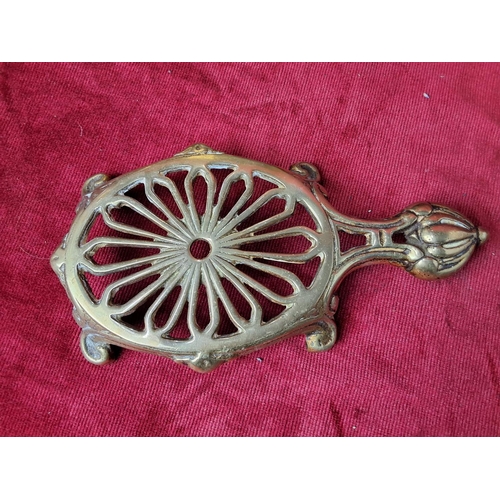 34 - An antique brass kettle & trivet.