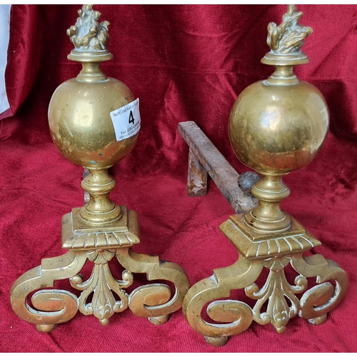 4 - A pair of decorative antique brass fire dogs.