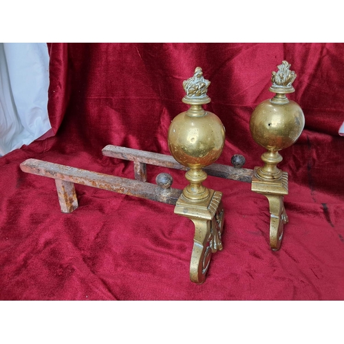 4 - A pair of decorative antique brass fire dogs.