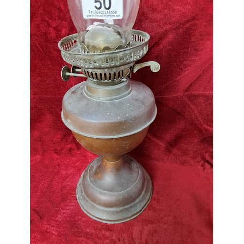 50 - A vintage/ antique copper based oil lamp, measuring 52cm tall.