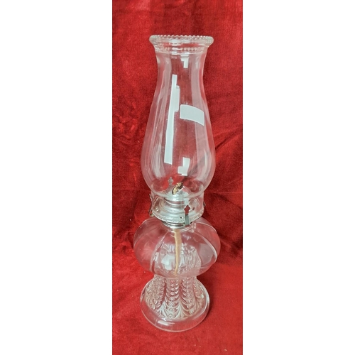 51 - A vintage oil lamp with glass font base, measuring approx 42 cm tall.