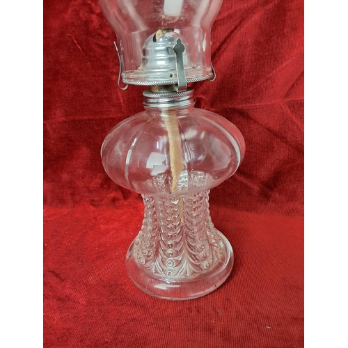 51 - A vintage oil lamp with glass font base, measuring approx 42 cm tall.