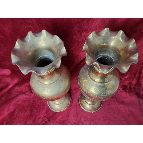 56 - A pair of decorative vintage Indian brass vases, each measuring approx 35cm tall.