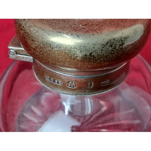 67 - An antique glass inkwell with Sterling Silver top.