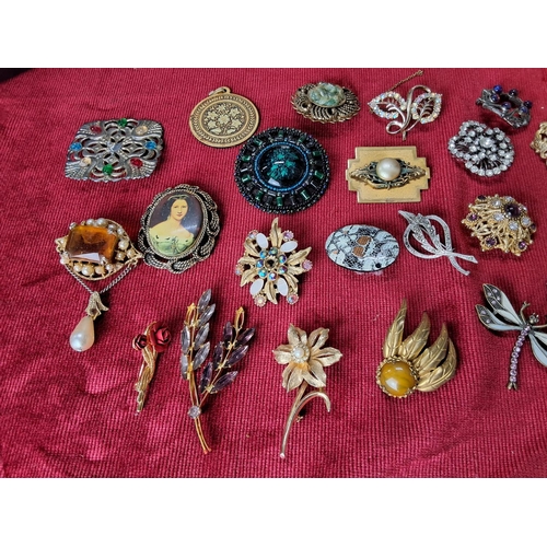 99 - A collection of vintage costume jewellery brooches & pendants.