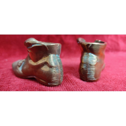 119 - A pair of vintage match holders in the form of brass boots.