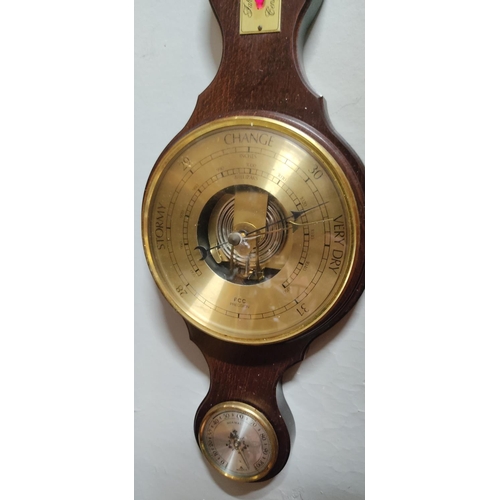 165 - A wood cased barometer. Measuring 65cm tall.