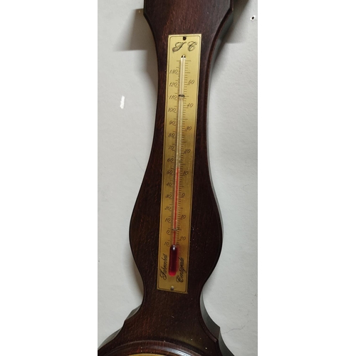 165 - A wood cased barometer. Measuring 65cm tall.