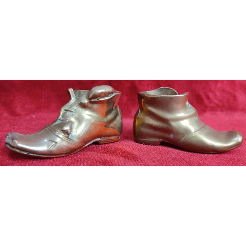 119 - A pair of vintage match holders in the form of brass boots.