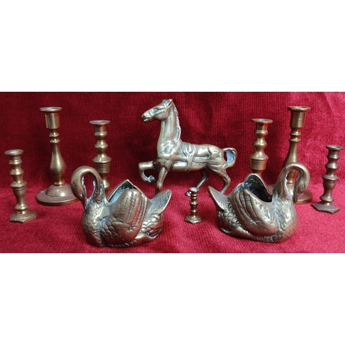 127 - A collection of brassware to include candlesticks, swan planters & more.