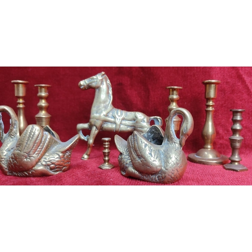 127 - A collection of brassware to include candlesticks, swan planters & more.