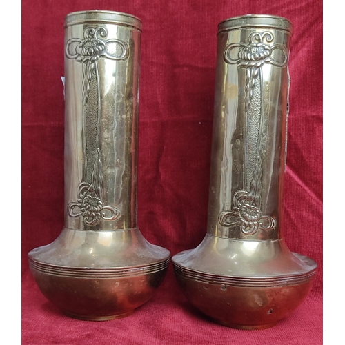 128 - A pair of antique Art Nouveau style brass vases, each measuring 26cm tall.