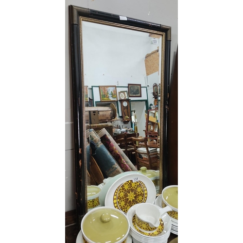 133 - A large antique style mirror with wood frame & bevelled glass. Measuring approx 101cm x 51cm.