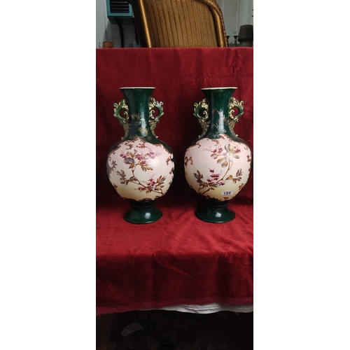 186 - A pair of stunning antique hand painted vases, each measuring 46cm tall. One has signs of old repair... 